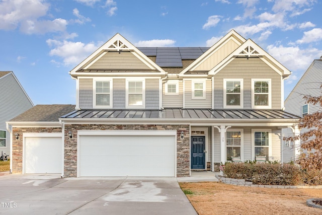 view of front of house featuring solar panels and a garage