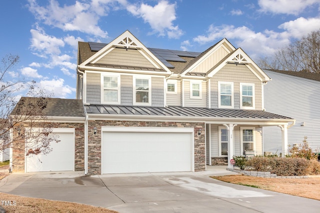 craftsman house featuring a garage and solar panels