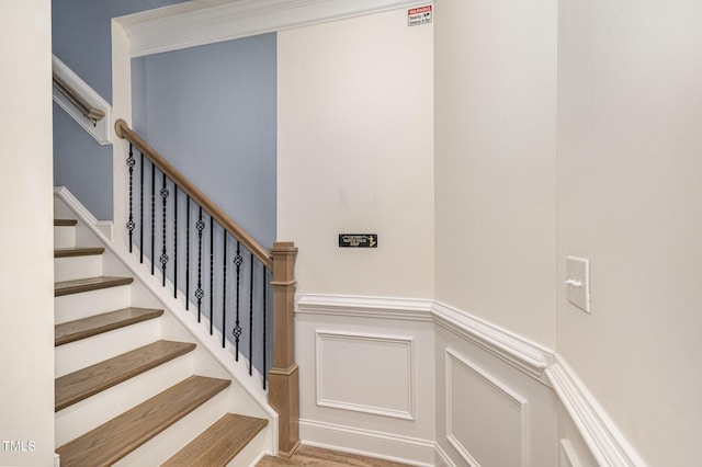 79 Stallion Way, Benson, NC 27504 - stairs with a wainscoted wall, a decorative wall, and wood finished floors