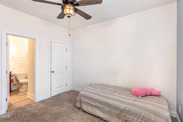 carpeted bedroom with connected bathroom and ceiling fan