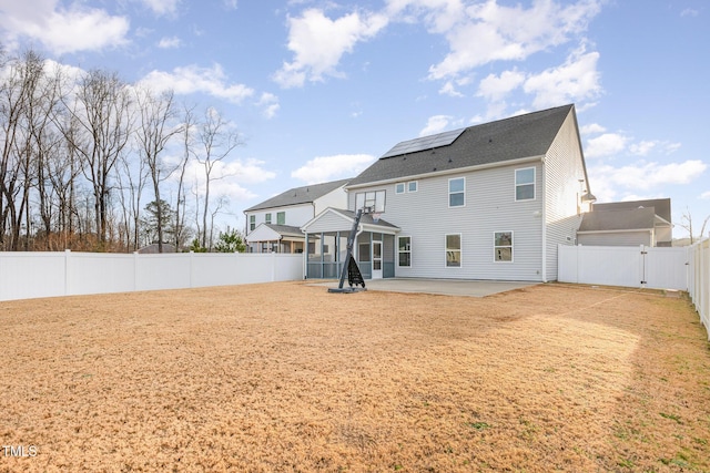 79 Stallion Way, Benson, NC 27504 - rear view of house with a patio, roof mounted solar panels, a fenced backyard, and a gate
