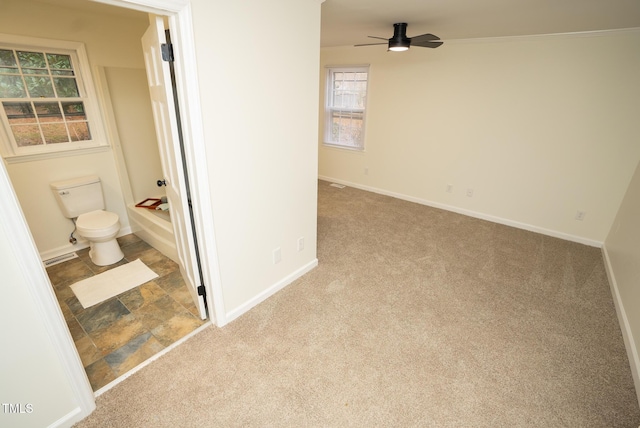 bathroom featuring ceiling fan and toilet