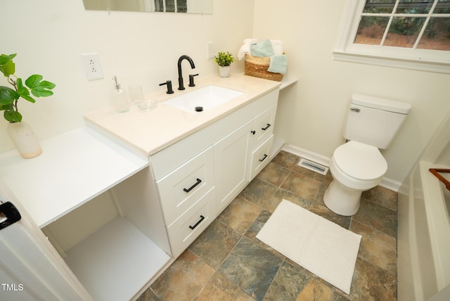 bathroom featuring vanity and toilet