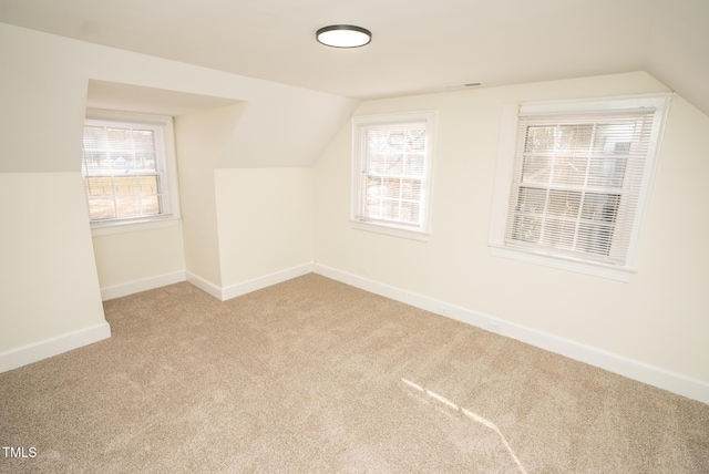 additional living space featuring carpet flooring and lofted ceiling