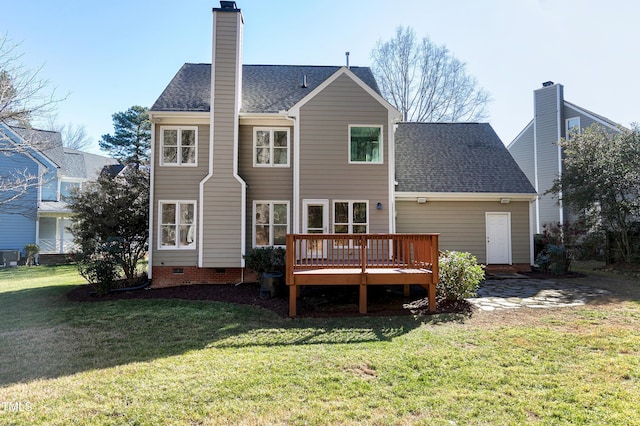 rear view of house featuring a wooden deck and a lawn