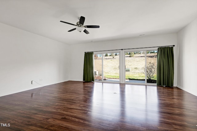 spare room with ceiling fan and dark hardwood / wood-style flooring