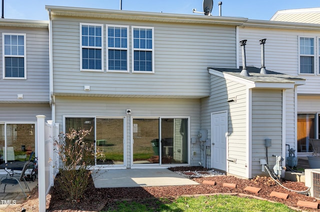 rear view of house with central AC unit and a patio area