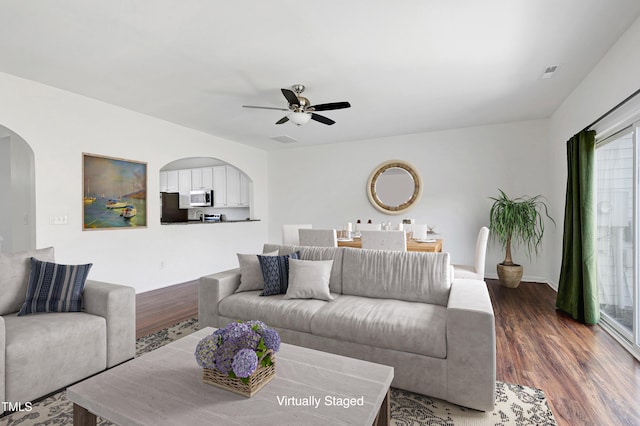 living room with ceiling fan and dark hardwood / wood-style floors