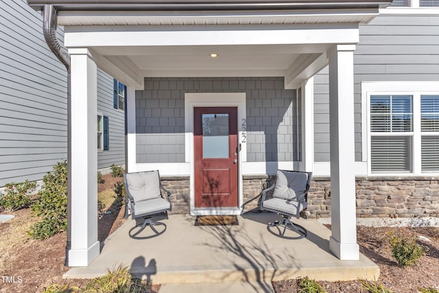 view of exterior entry with covered porch