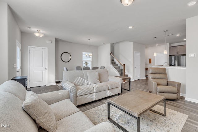 living room with a notable chandelier and dark wood-type flooring