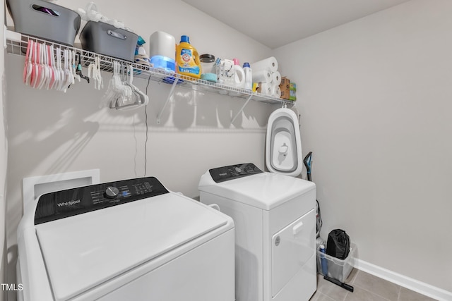 washroom with separate washer and dryer and light tile patterned flooring