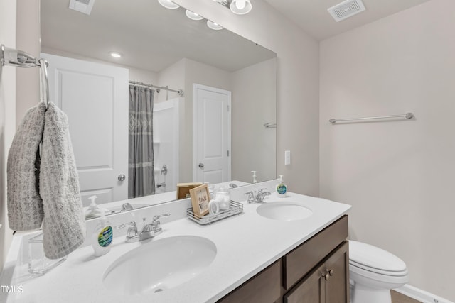 bathroom with vanity, toilet, and curtained shower