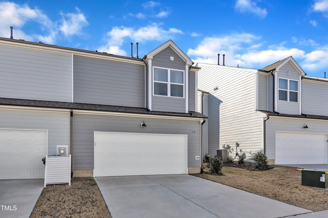 view of front of home featuring central AC unit and a garage