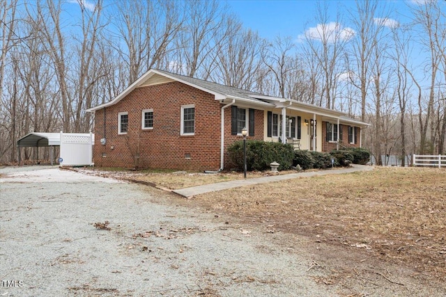 view of front of property featuring covered porch and a carport