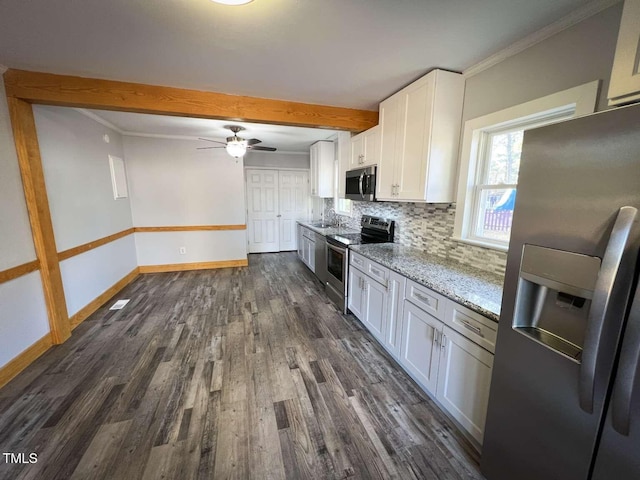 kitchen featuring appliances with stainless steel finishes, tasteful backsplash, light stone counters, sink, and white cabinetry