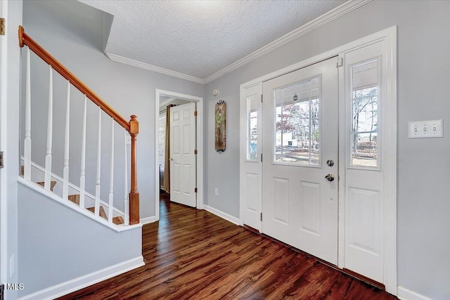 entryway with ornamental molding, dark hardwood / wood-style flooring, and a textured ceiling