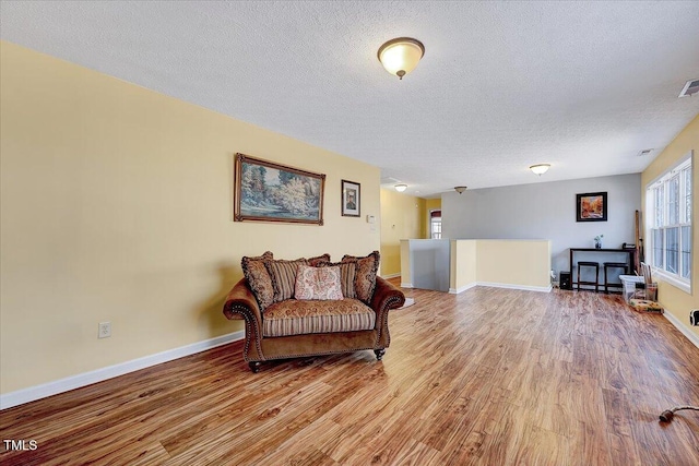 sitting room featuring hardwood / wood-style flooring and a textured ceiling