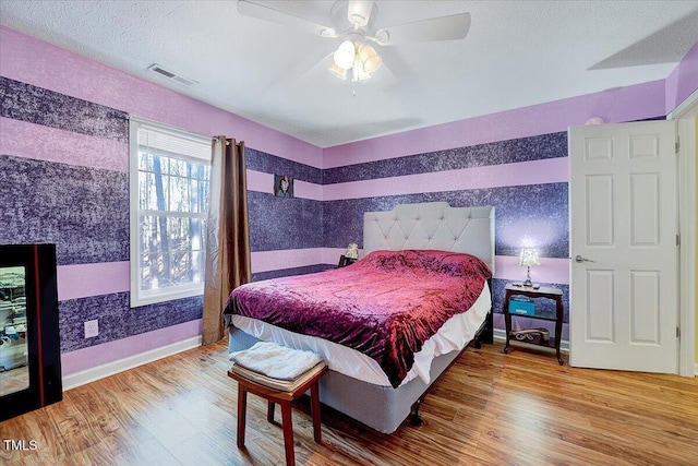 bedroom with ceiling fan and wood-type flooring