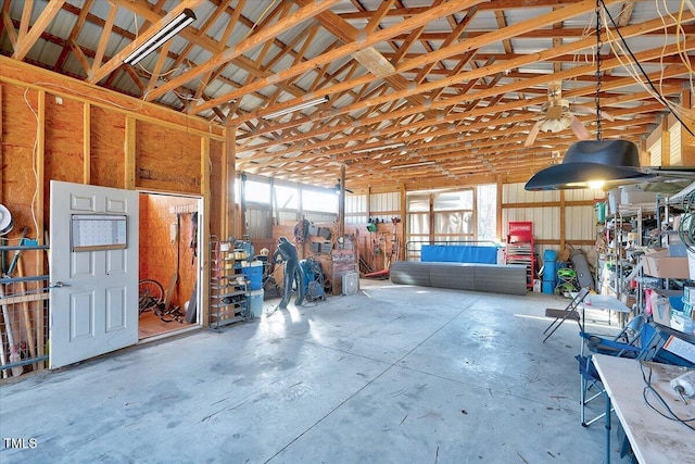 miscellaneous room featuring concrete floors and high vaulted ceiling