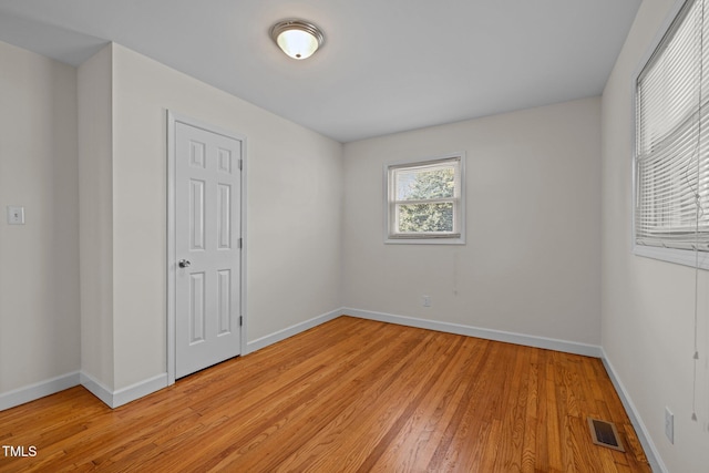 spare room featuring light hardwood / wood-style flooring