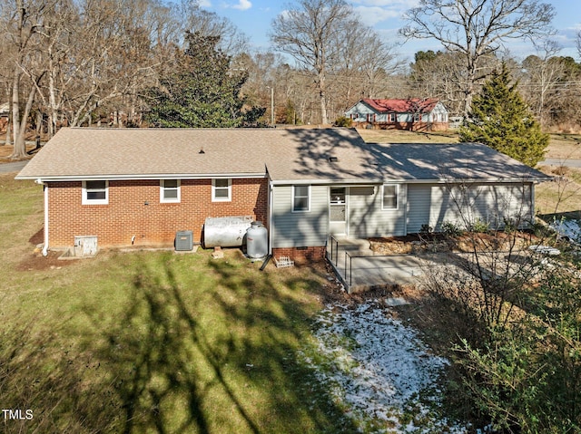 rear view of property with a lawn