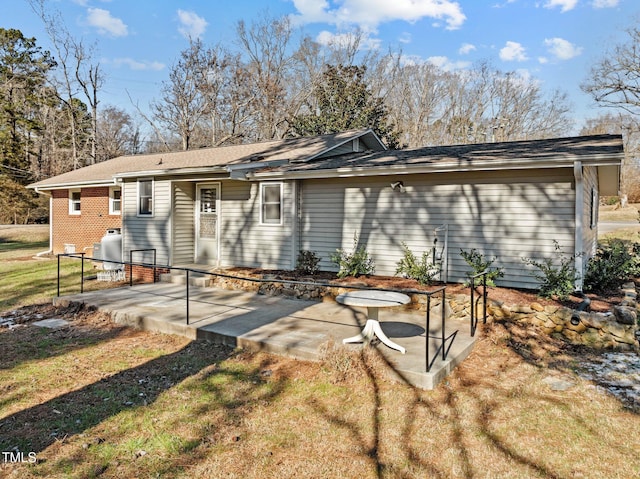 rear view of house with a patio and a lawn