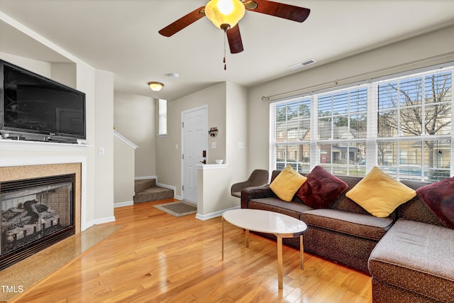 living room with ceiling fan and wood-type flooring