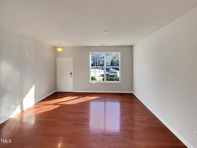 unfurnished room with hardwood / wood-style flooring