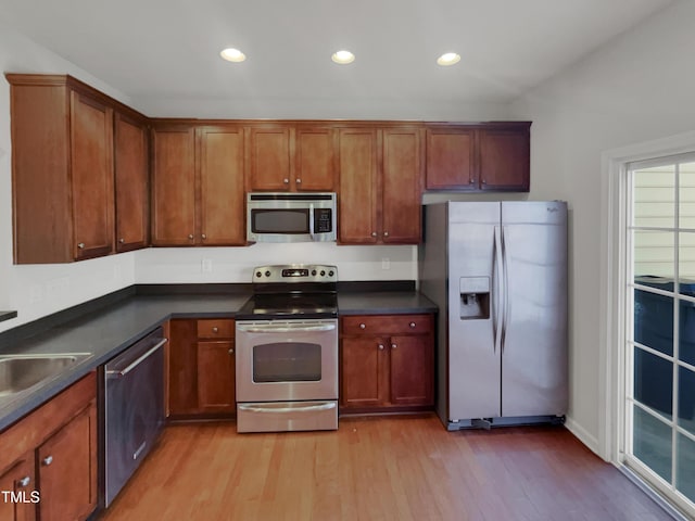 kitchen with sink, light hardwood / wood-style flooring, and appliances with stainless steel finishes