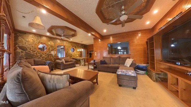 cinema featuring light carpet, a textured ceiling, ceiling fan, beamed ceiling, and wood walls