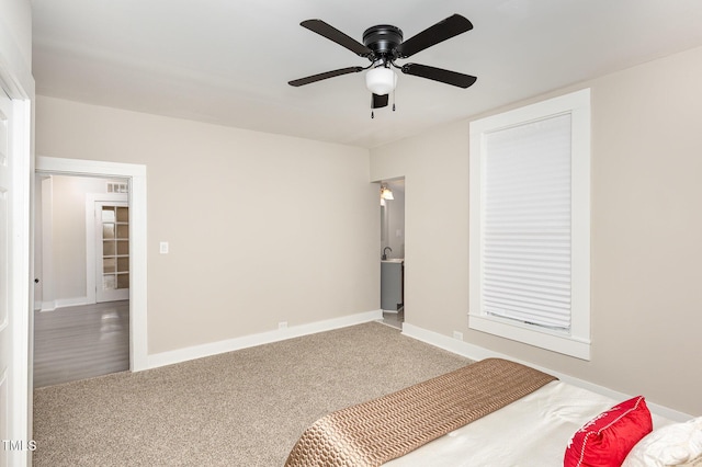 carpeted bedroom featuring a ceiling fan and baseboards