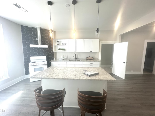 kitchen featuring electric stove, sink, white cabinetry, hanging light fixtures, and light stone countertops