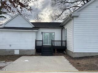 back of property with a wooden deck