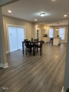 dining room with dark wood-type flooring, recessed lighting, and baseboards