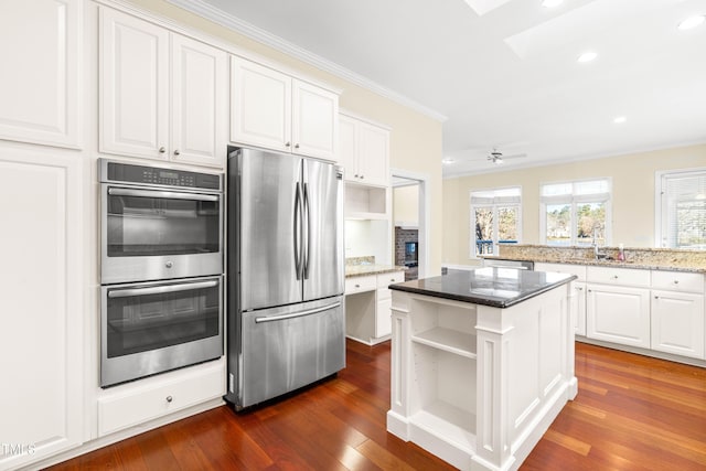 kitchen with white cabinetry, appliances with stainless steel finishes, and open shelves