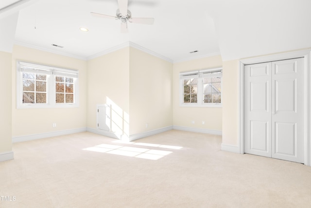 unfurnished bedroom with light colored carpet, crown molding, visible vents, and baseboards