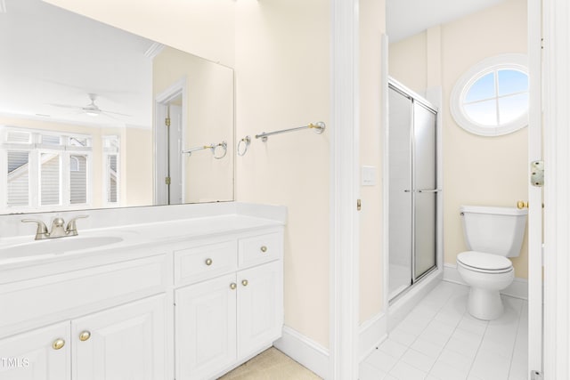 full bathroom with a stall shower, baseboards, a ceiling fan, toilet, and vanity