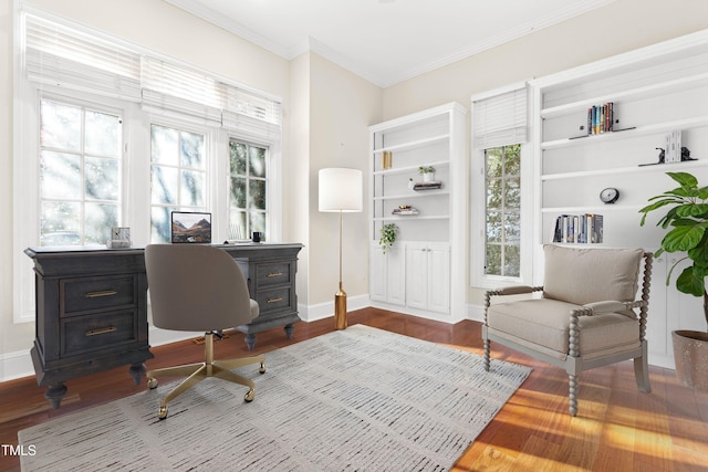 office area with ornamental molding, wood finished floors, and baseboards