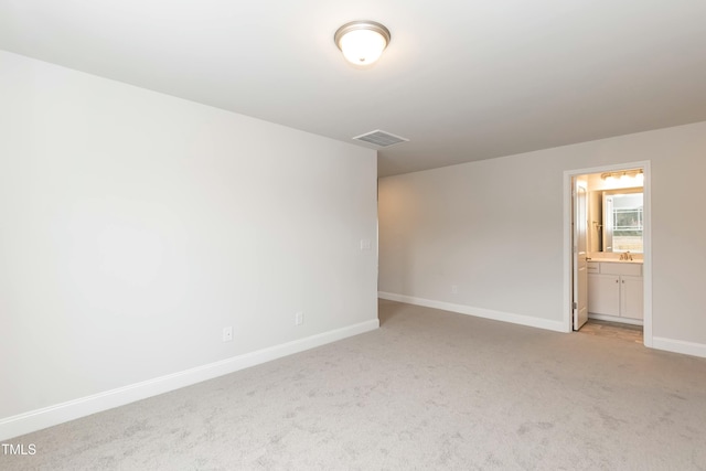 carpeted spare room with sink