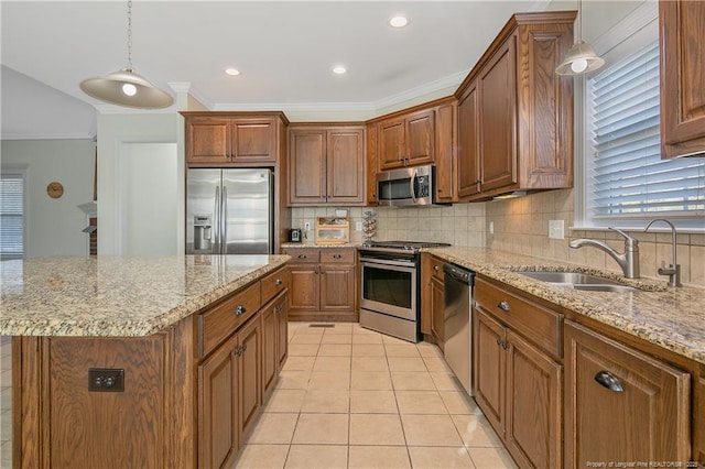 kitchen with sink, stainless steel appliances, hanging light fixtures, and light tile patterned flooring