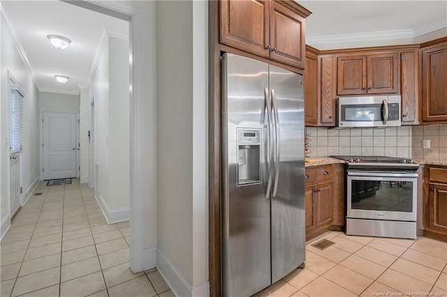 kitchen with stainless steel appliances, light stone counters, and crown molding