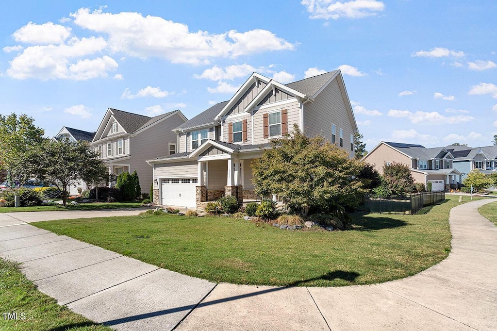 view of front of property with a front yard and a garage