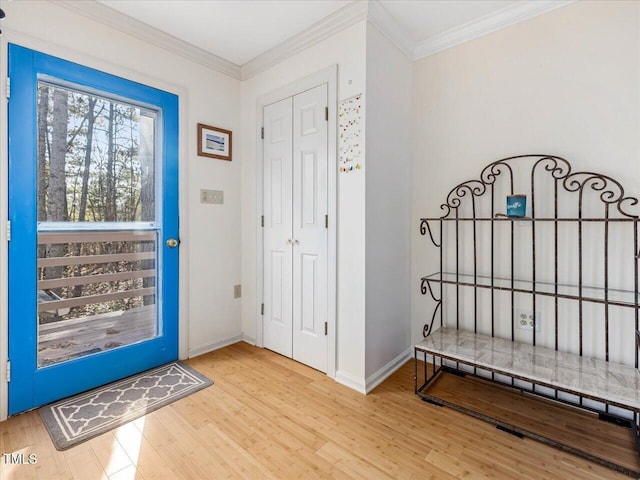 entryway featuring crown molding and light hardwood / wood-style flooring