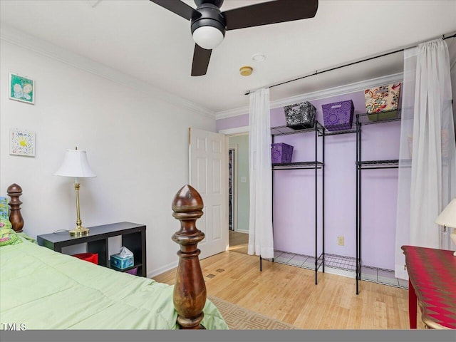 bedroom featuring ceiling fan, crown molding, and wood-type flooring