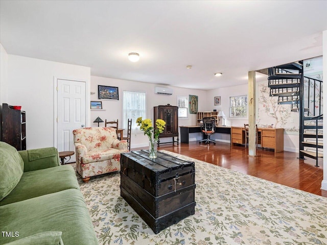 living room featuring hardwood / wood-style floors and a wall unit AC