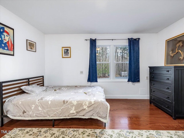 bedroom with dark wood-type flooring