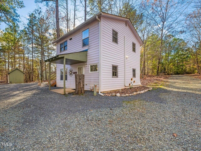 view of front of house with a storage shed