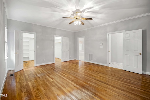 interior space with ceiling fan, light wood-type flooring, and ornamental molding