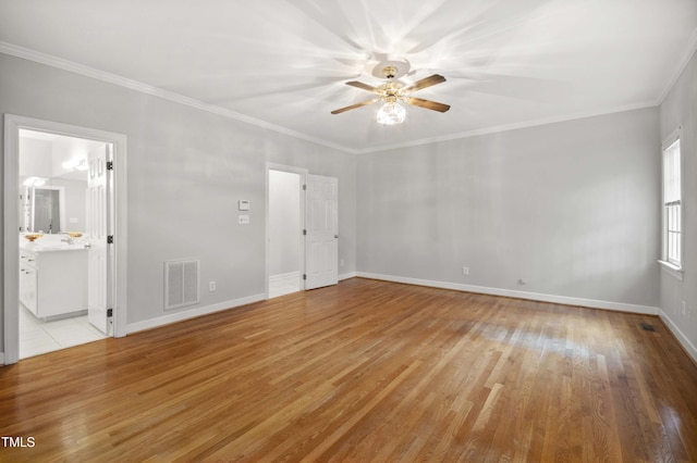 empty room with crown molding, light hardwood / wood-style flooring, and ceiling fan