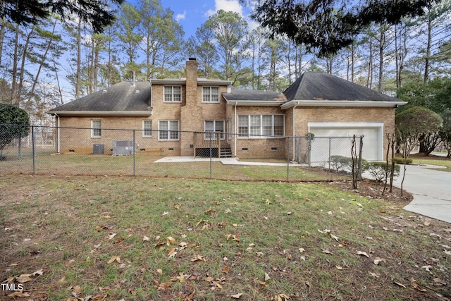 back of house featuring a lawn, a garage, and central AC